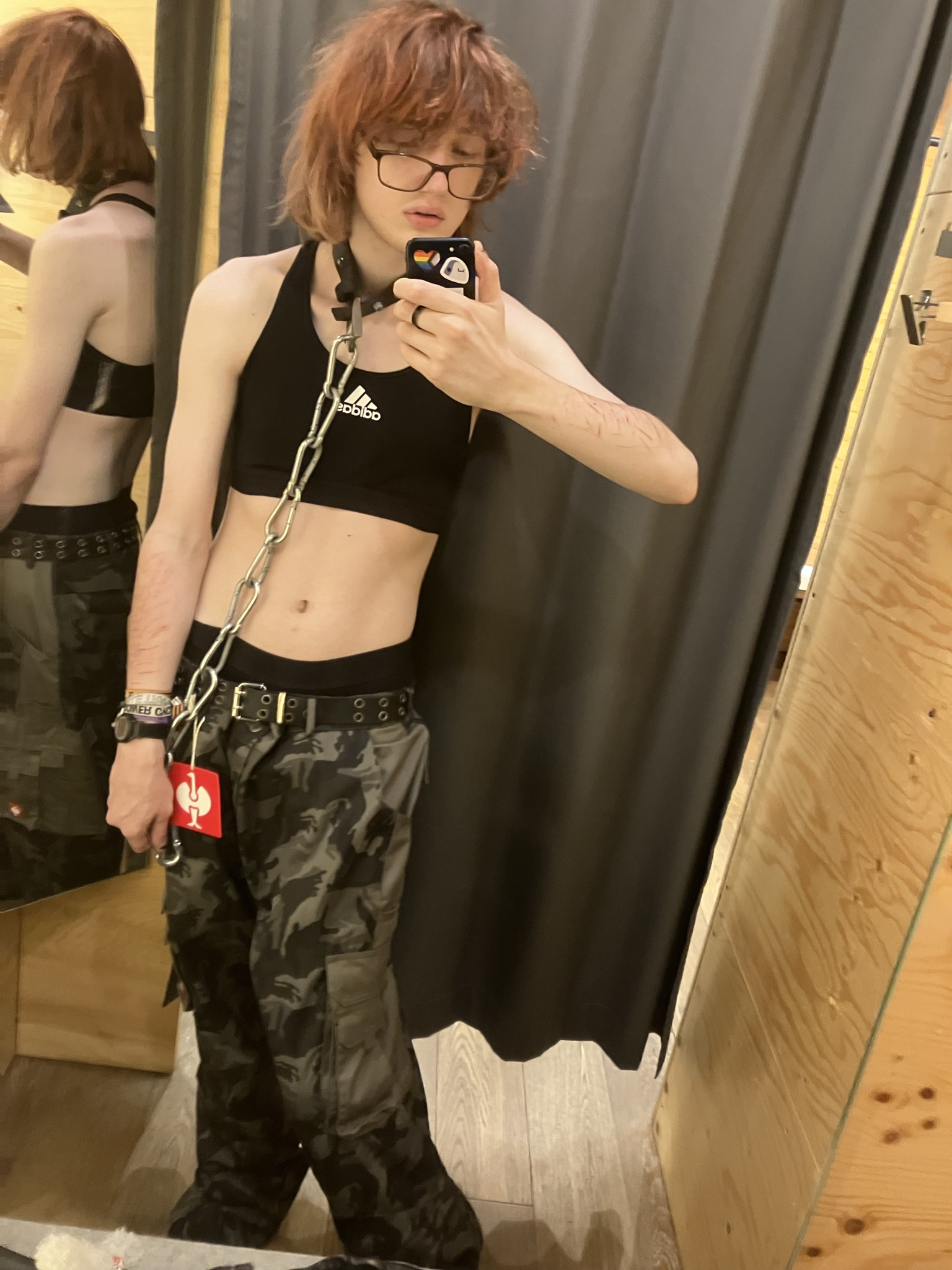 me in the changing room of the engelbert strauss store wearing a sports bra and the engelbert strauss camp pants. the tag is still attached
